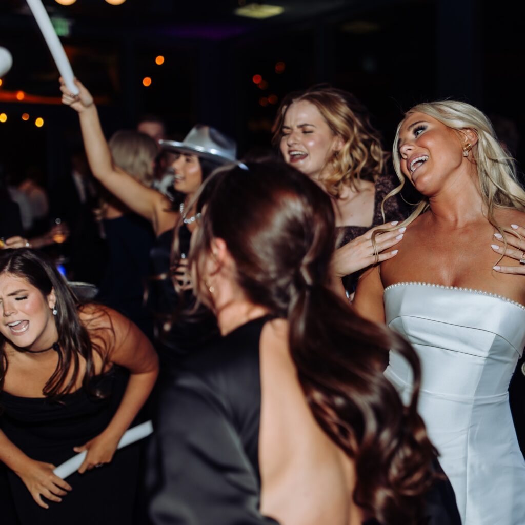 Bride and friends dancing and singing at reception